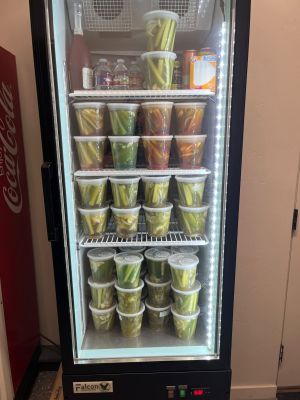 Commercial refrigerator stocked with Burque Brine pickle containers