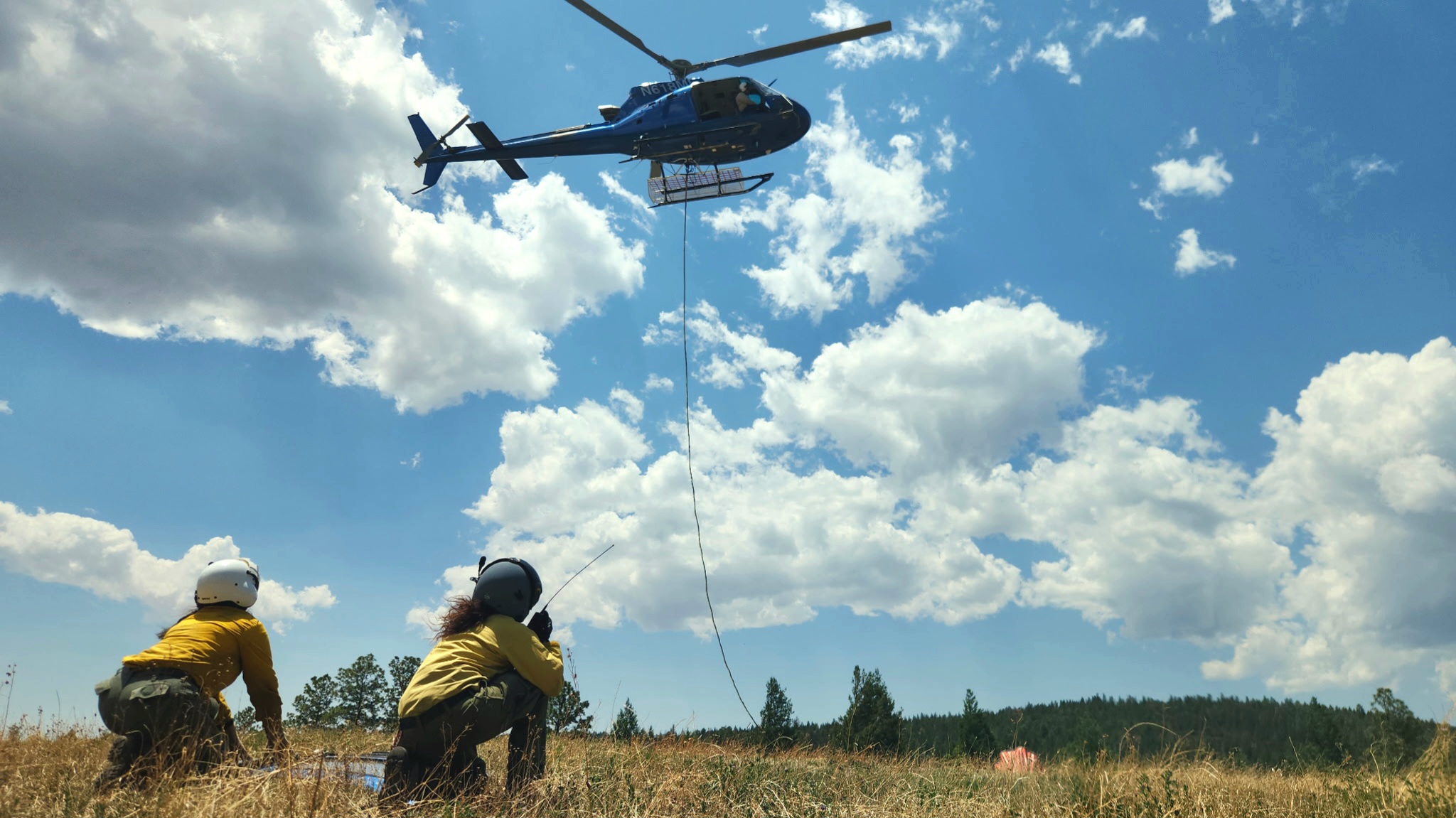 Mountain Air helicopter and ground crew during field operations