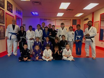 Kids Brazilian Jiu-Jitsu class team photo with instructors