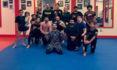 Eric Pedro BJJ team posing on the mats in no-gi gear