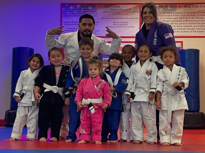 Youth Brazilian Jiu-Jitsu students and instructors on the mats